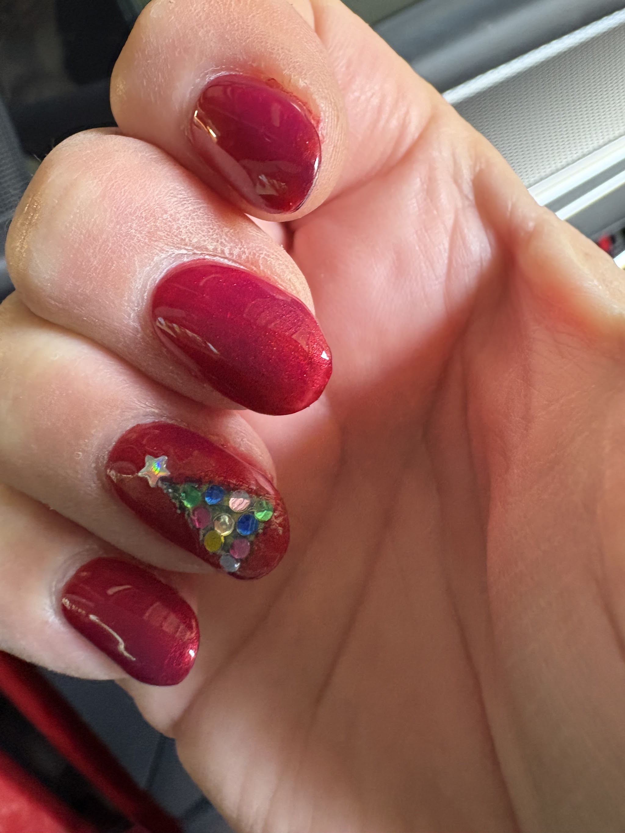 Deep red glitter gel with a rhinestone Christmas tree accent nail