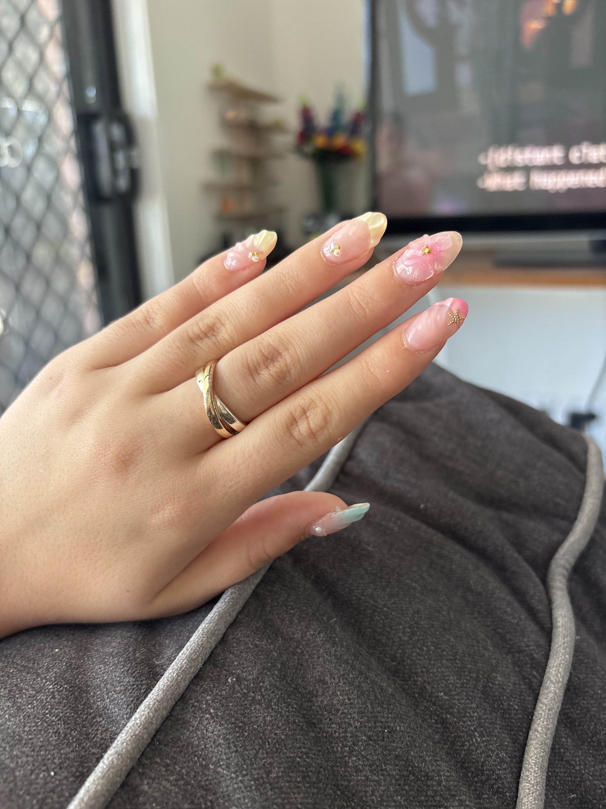 Pink and white ombre nails with 3D flowers and gold stars