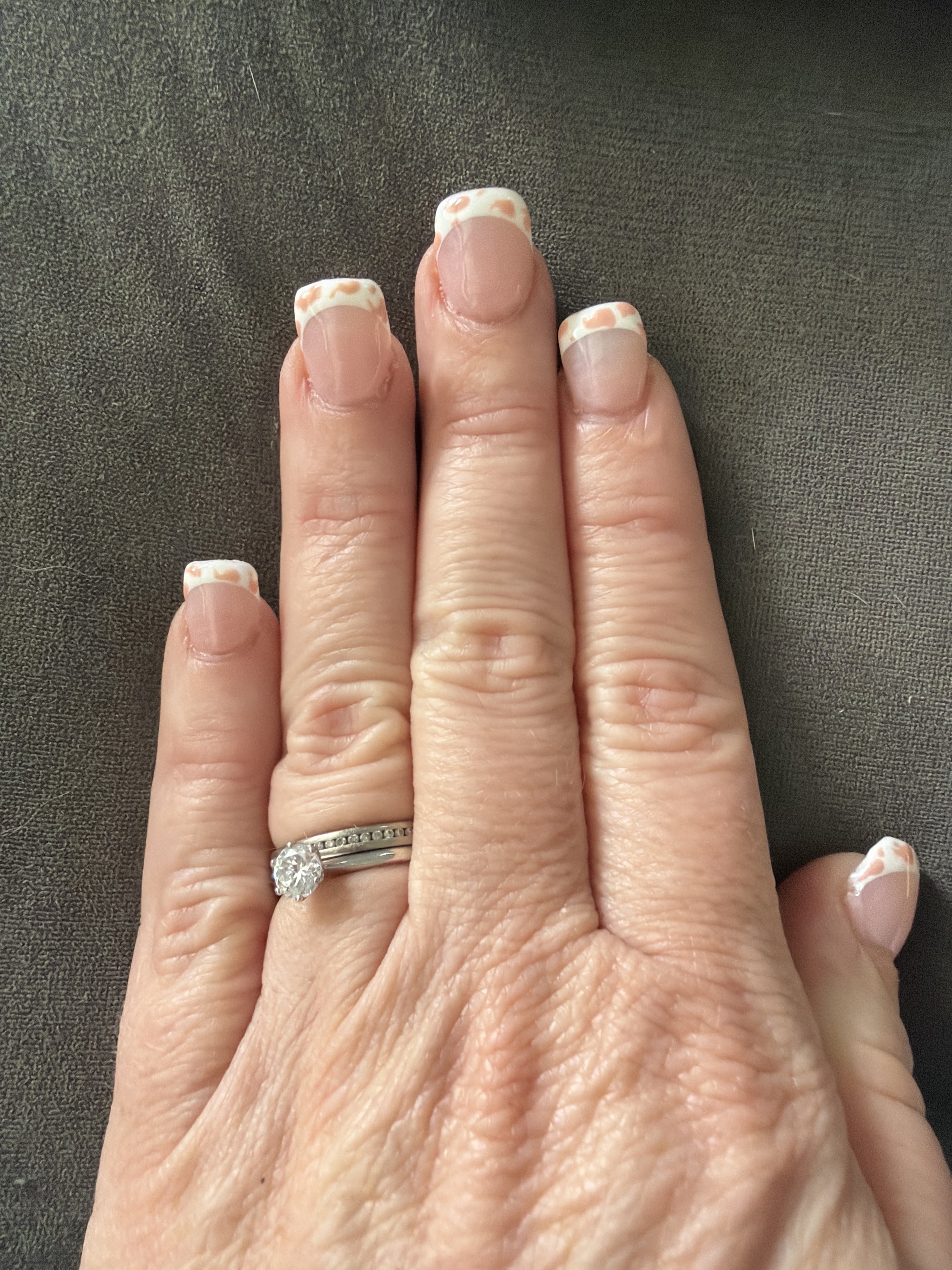 White French tips with peach leopard-print accent tips