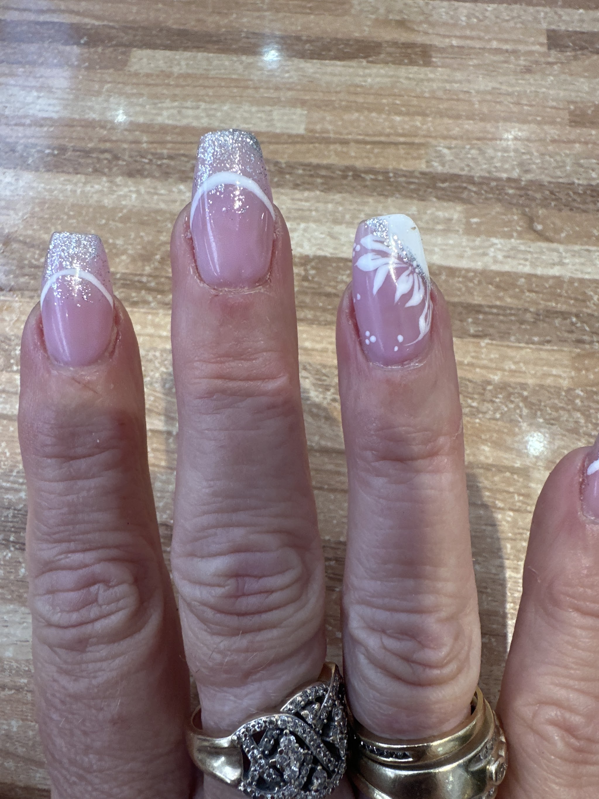 Silver glitter French ombre with a hand-painted white lily